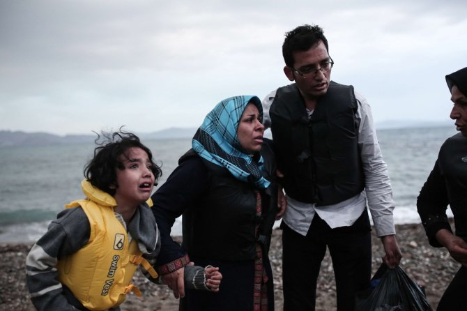 AFP/„Scanpix“ nuotr./Graikijos Koso saloje išsilaipinę pabėgeliai iš Afganistano ir Sirijos