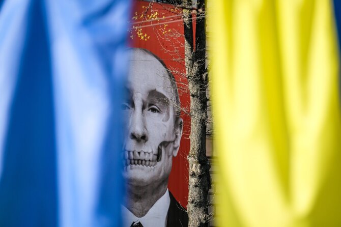 „Shutterstock“ nuotr./Plakatas su Vladimiro Putino atvaizdu