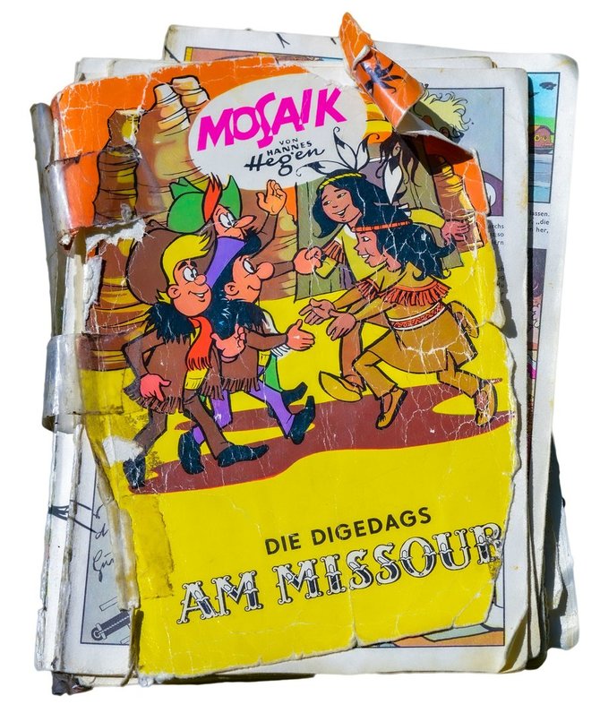 Suskaityta Hano Hegeno komiksų knyga apie Digo, Dagi ir Digedago nuotykius „Prie Misurio“ (pirmą kartą išleista 1976 m., antras leidimas 1990 m., VDR)