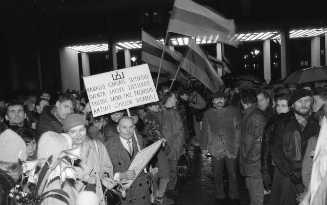 Organizatorių nuotr./Zenonas Nekrošius. 1990 m. Kovo 11-oji. Su plakatu kanklininkas Antanas Bujokas