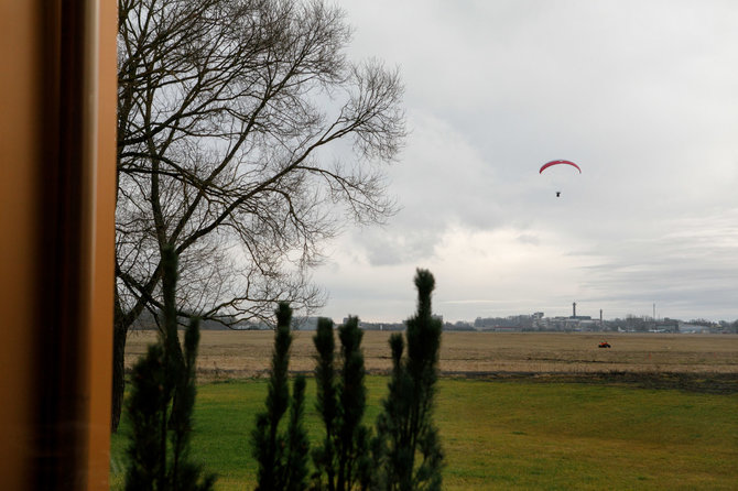 Eriko Ovčarenko / 15min nuotr./„Aeronamai“ gyventojai per savo langus mato seniausią Lietuvos aerodromą ir jame skraidančius aviacijos mėgėjus