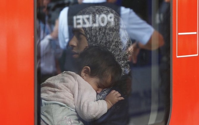 AFP/„Scanpix“ nuotr./Papėgėliai plūsta į Vokietiją