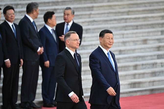 Lenkijos prezidentas Andrzejus Duda vieši Kinijoje. / PEDRO PARDO / AFP