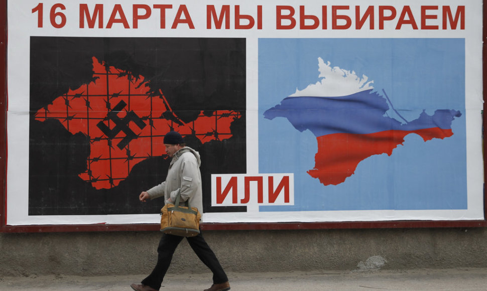 A man walks past a poster calling people to vote in a referendum in the Crimean city of Sevastopol March 16, 2014. Residents of the Crimean penisular prepared to vote in a referendum on Sunday that is widely expected to transfer control of the Black Sea region from Ukraine to Moscow, despite an outc