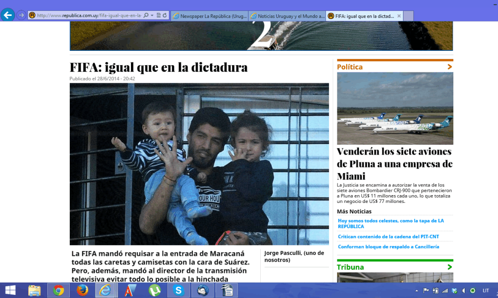 Laikraštis su Luiso Suarezo, laikančio ant rankų vaikus, nuotrauka