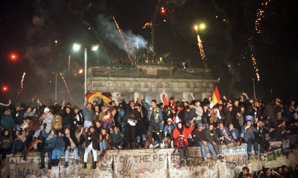 Žmonės švenčia pasitinkant 1990 metus prie Berlyno sienos