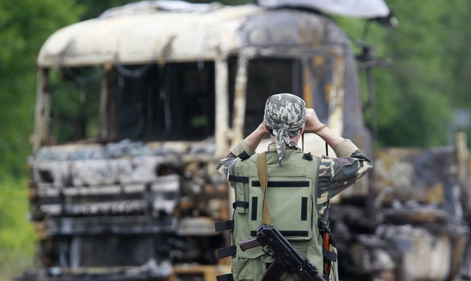 Rusų teroristas netoli sudeginto vilkiko, prie patikrinimo posto Luhanske