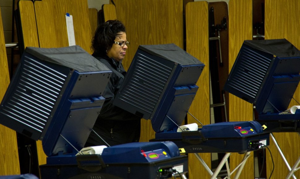 Amerikietė atiduoda balsą balsavimo mašinoje 2012 metų prezidento rinkimuose