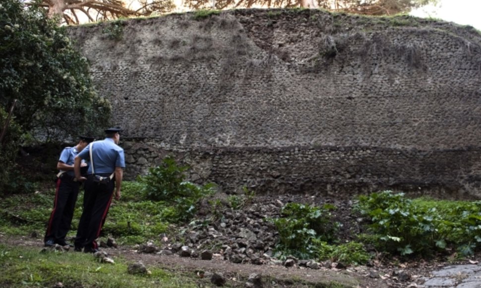 Karabinieriai stovi prie nugriuvusios sienos dalies Pompėjoje.