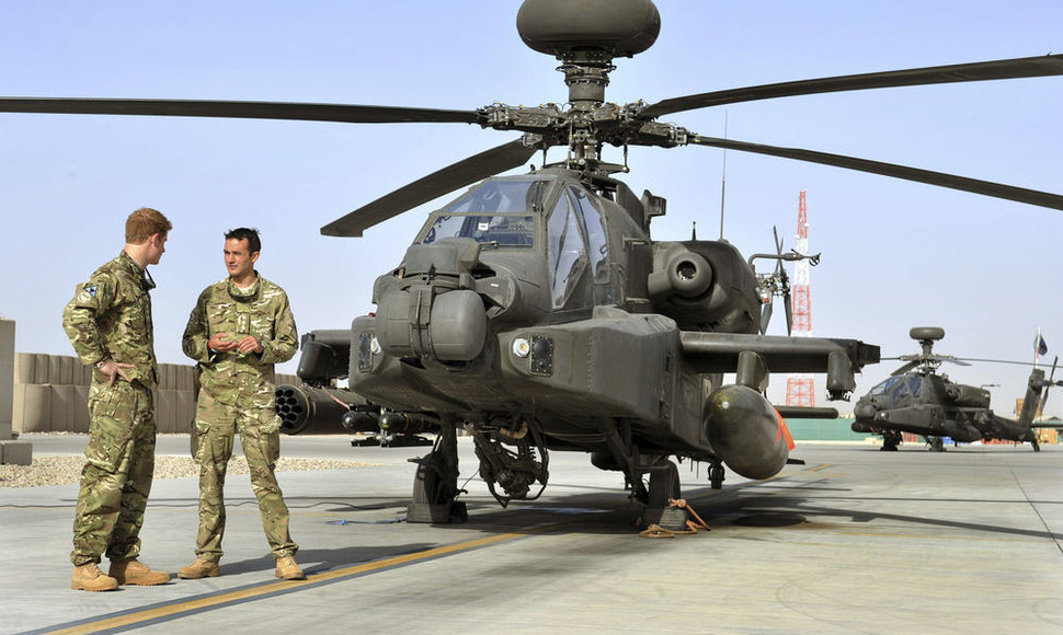 Princas Harry (kairėje) „Kemp Bastiono“ bazėje stovi prie sraigtasparnio „Apache“.
