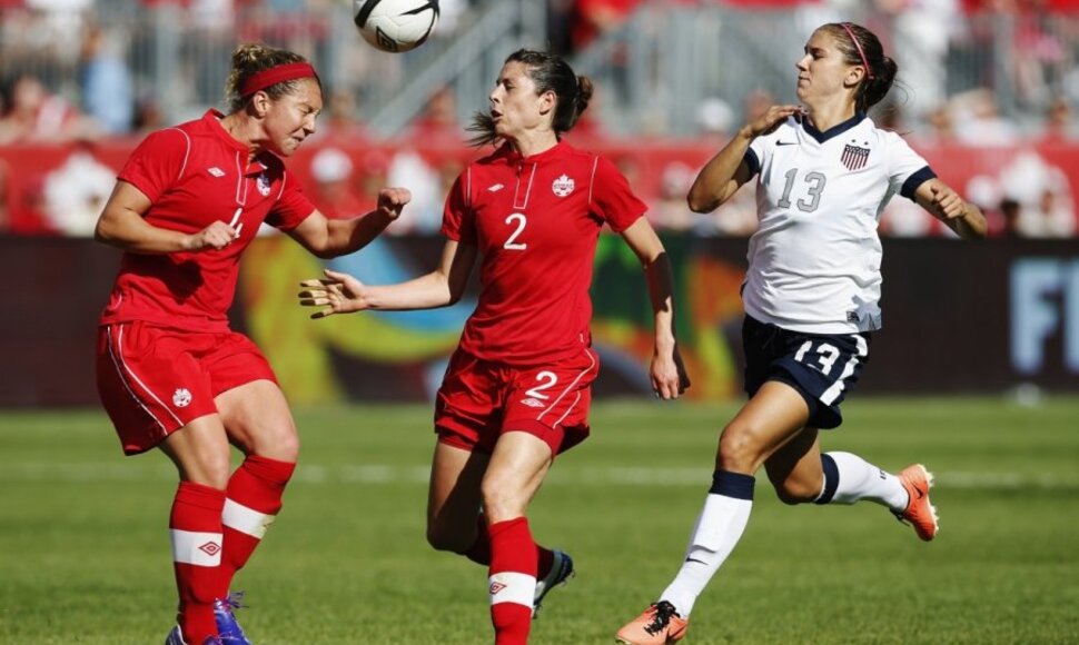 Alex Morgan (Nr.13) kovoja su dviem varžovėmis