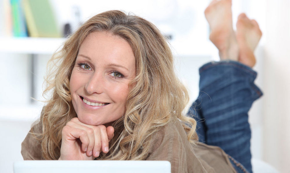 Smiling happy woman using a laptop