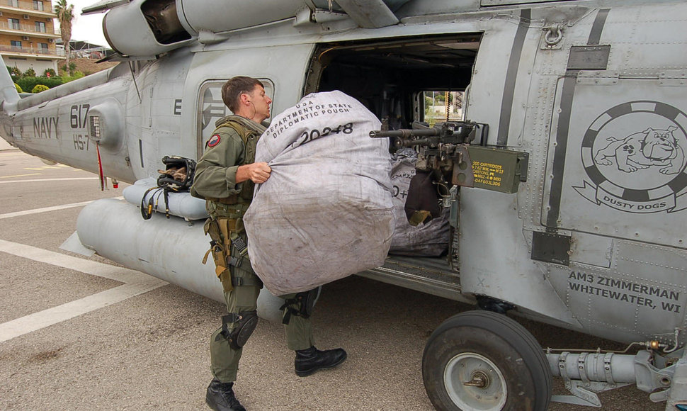 Krepšys su amerikiečių diplomatiniu paštu yra kraunamas į sraigtasparnį