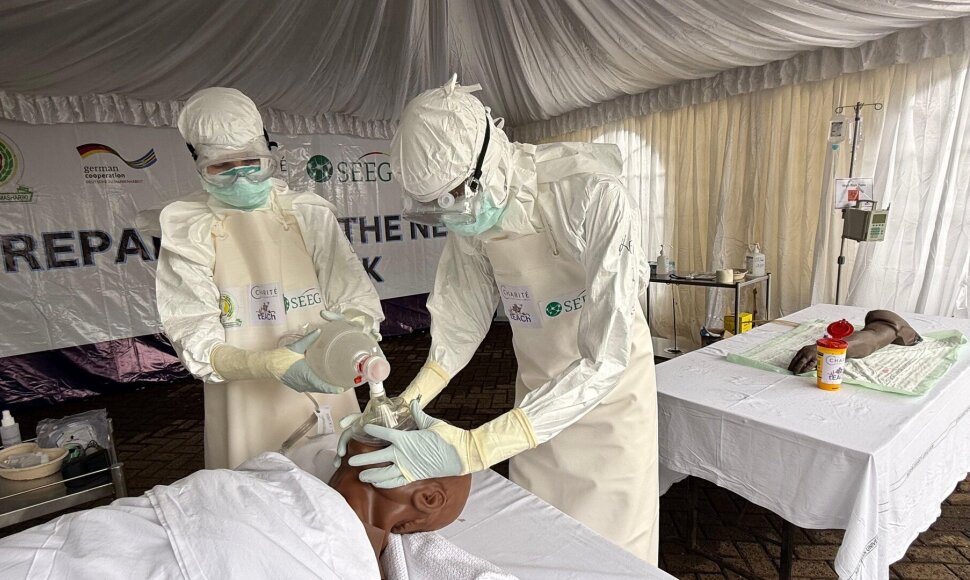 Gydytojai mobilioje laboratorijoje, kurios naudojamos Ebola viruso atvejams nustatyti