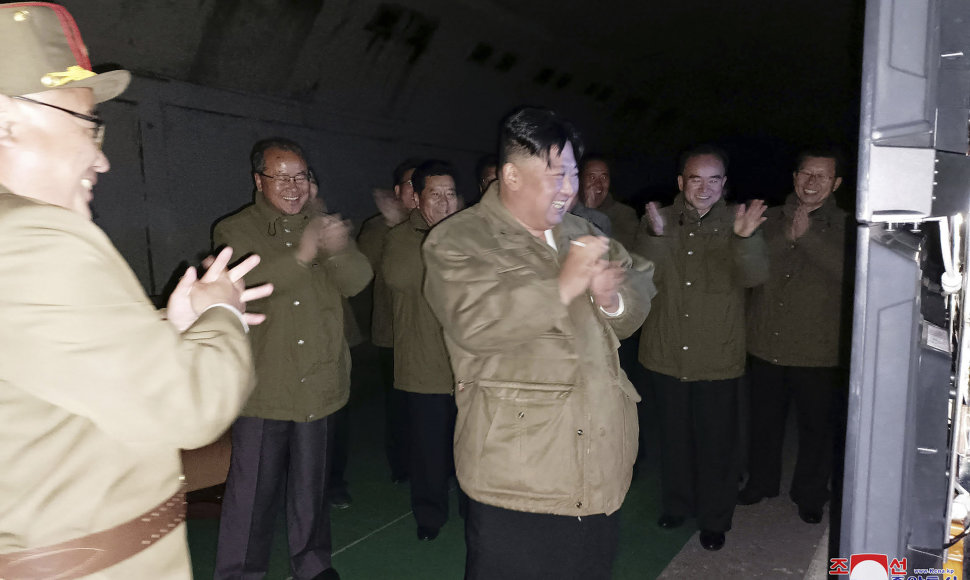 Kim Jong Unas stebi raketos paleidimą.